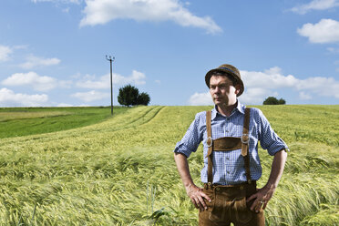 Germany, Bavaria, Farmer standing in field and looking away - MAEF006901