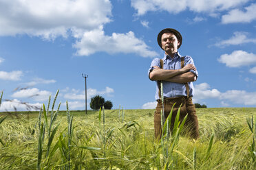 Germany, Bavaria, Farmer standing with arms crossed in field - MAEF006899