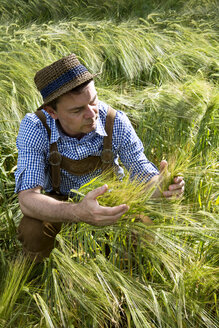 Germany, Bavaria, Farmer harvesting in field - MAEF006898