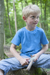 Germany, Bavaria, Munich, Boy carving branch, looking away - NH001395