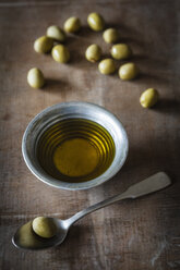 Olives and olive oil on table, close up - EVG000140