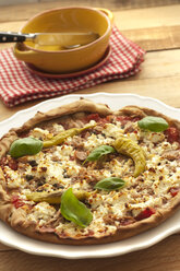 Pizza with feta, tuna and chillies on wooden table, close up - OD000187