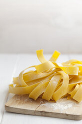 Homemade fettuccine on chopping board, close up - ECF000249