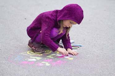 Germany, Girl drawing on street with chalk - SARF000050