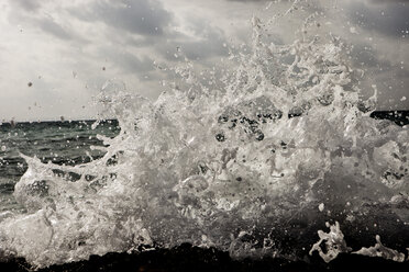 Spain, Water bursting at beach - SKF001407