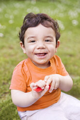 Baby boy holding spoon, smiling - MFF000568