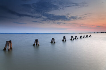 Austria, Burgenland, View of piles on Lake Neusiedl at dusk - GFF000136