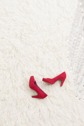 Red High Heels laying on white carpet - DRF000029