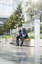 Germany, Hannover, Businessman using smart phone - KFF000200