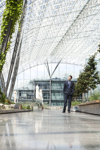 Businessman standing in courtyard stock photo