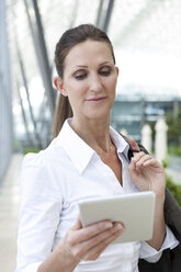 Businesswoman holding digital tablet - KFF000123