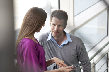 Businessman and businesswoman with digital tablet - KFF000173