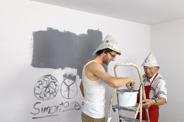 Germany, Grandfather and grandson painting wall - LAF000107