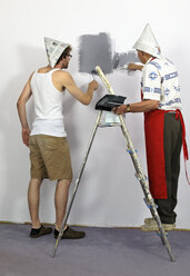 Germany, Grandfather and grandson painting wall - LAF000119