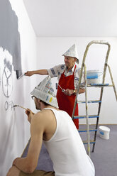 Germany, Grandfather and grandson painting wall - LAF000115