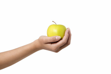 Human holding green apple against white background, close up - GDF000119