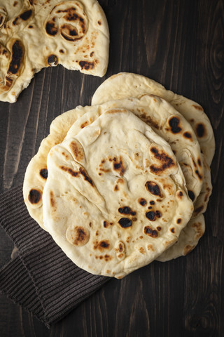 Flat breads on wooden table, close up stock photo