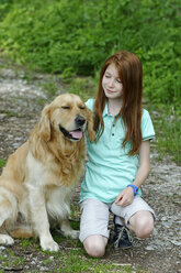 Germany, Bavaria, Girl caring dog, smiling - LB000251