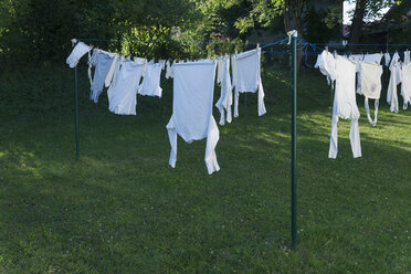 Germany, Bavaria, Munich, Clothes hanging on washing line - TCF003521