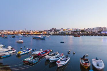 Portugal, Lagos, Fishing boats at harbour and city in background - WDF001890