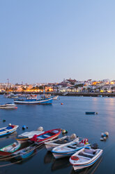 Portugal, Lagos, Blick auf Fischerboot im Hafen und Stadt im Hintergrund - WDF001889