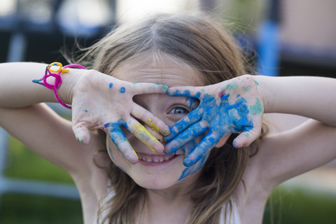 Germany, Bavaria, Girl playing with finger paint, close up stock photo