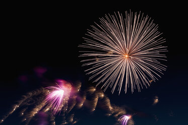 Germany, North Rhine Westphalia, Duesseldorf, Fireworks exploding in sky - KJF000249