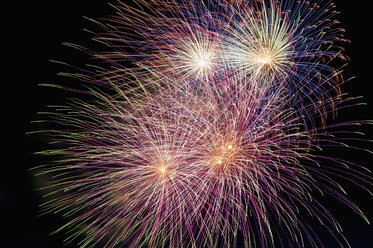 Germany, North Rhine Westphalia, Duesseldorf, Fireworks exploding in sky - KJF000243