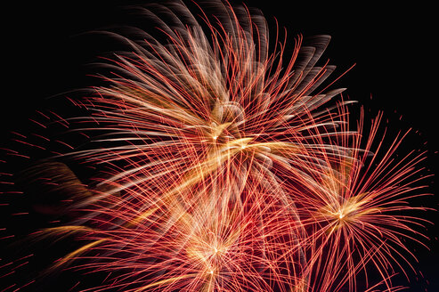 Germany, North Rhine Westphalia, Duesseldorf, Fireworks exploding in sky - KJF000241
