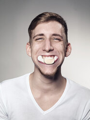 Portrait of Young man mouth suffed with marshmallow and candy - STKF000304