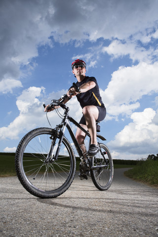 Deutschland, Bayern, Älterer Mann fährt Mountainbike, lizenzfreies Stockfoto