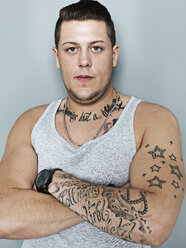 Portrait of young man with tattoos, close up - STKF000337