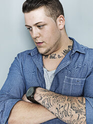 Portrait of young man with tattoo, close up - STKF000334