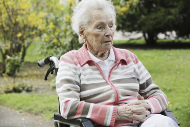 Germany, North Rhine Westphalia, Cologne, Senior woman sitting on wheelchair - JAT000181