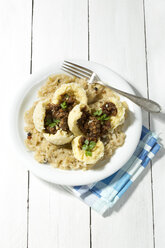 Griebenknödel mit Sauerkraut auf Holztisch, Nahaufnahme - MAEF007208