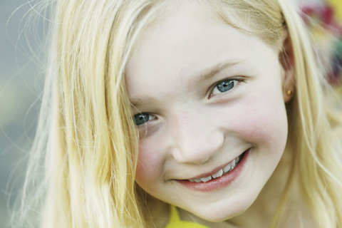 Germany, North Rhine Westphalia, Cologne, Portrait of girl, smiling, close up stock photo