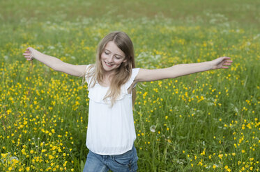 Germany, Bavaria, Girl walking in meadow - CRF002464