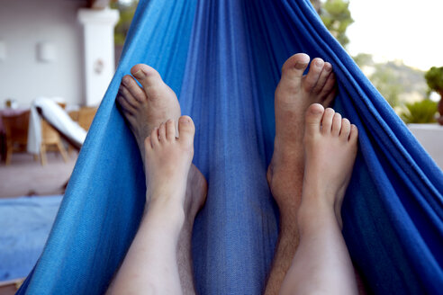 Spain, Mid adult man and boy legs relaxing on hammock - TKF000156