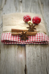 Weihnachtskugeln mit Sternanis und Zimt auf Holztisch, Nahaufnahme - OD000318