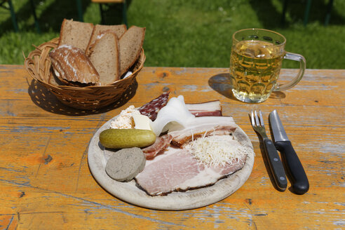 Österreich, Kärnten, Fleischteller mit Aufschnitt, Brot und Bierglas auf Tisch - SIEF004281