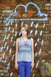 Germany, Berlin, Portrait of teenage girl standing in front of wall with graffiti - MVC000019