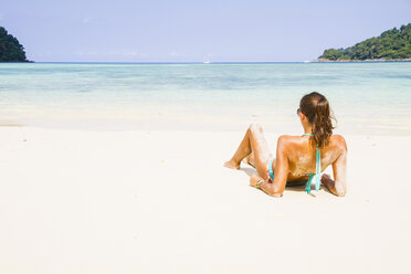 Thailand, Insel Koh Surin, Frau liegt am weißen Sandstrand - MBEF000722