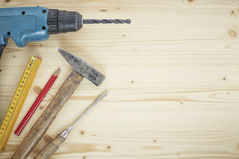 Drill, pencil, hammer, screwdriver, folding ruler on wood, close up - DSCF000103