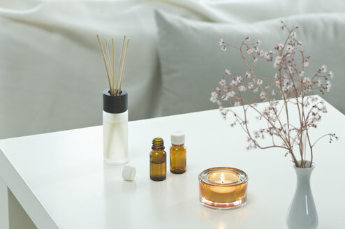 Aromatheraphy, candle, scent, fragrance diffuser, aroma sticks, aroma oil, with a bed visible in the backgroud, studio - ASF005120