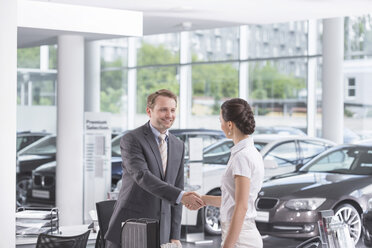 At the car dealer, Salesman and client shaking hands - MLF000027