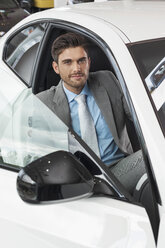 At the car dealer, Man sitting in new car - MLF000077