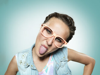 Young woman sticking out her tongue - STKF000353