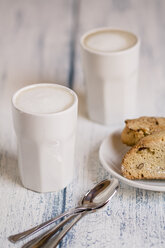 Cups of latte macchiatto with almond biscuits on wooden board - SBDF000199