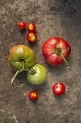 Oxheart tomatoes on stone surface - SBD000201