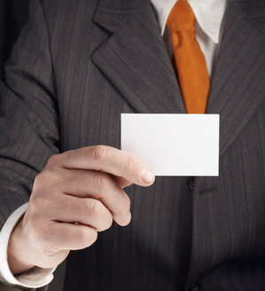 Businessman showing business card - BSCF000361